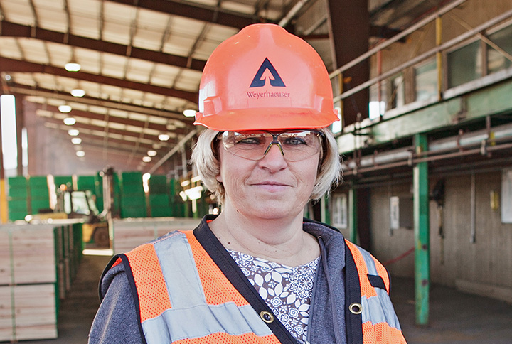 A worker standing at a Weyerhaeuser mill.