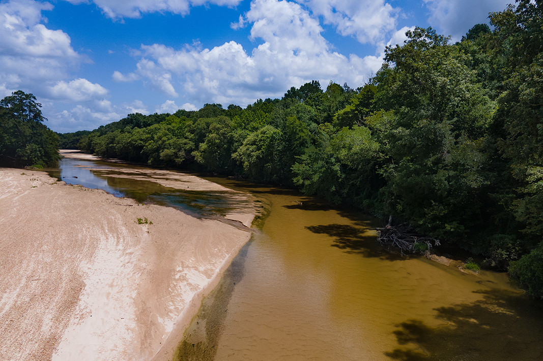 A waterway bordered by forests