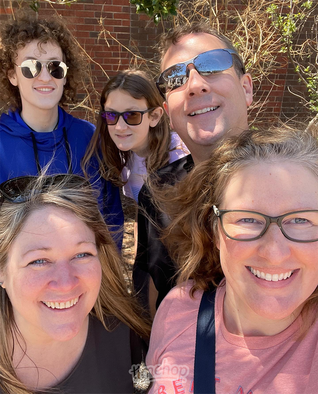 Image of Torri with her family on a scavenger hunt. Torri is in the lower right-hand side of the picture and is wearing glasses and a pink t-shirt. Her sister-in-law is next to her. Torri's nephew, niece and brother are in the back row.