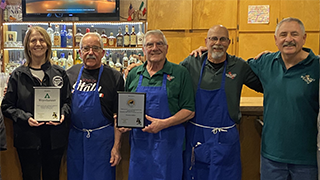 Image of Deborah Leedy and members of the Sons of Italy at an event.