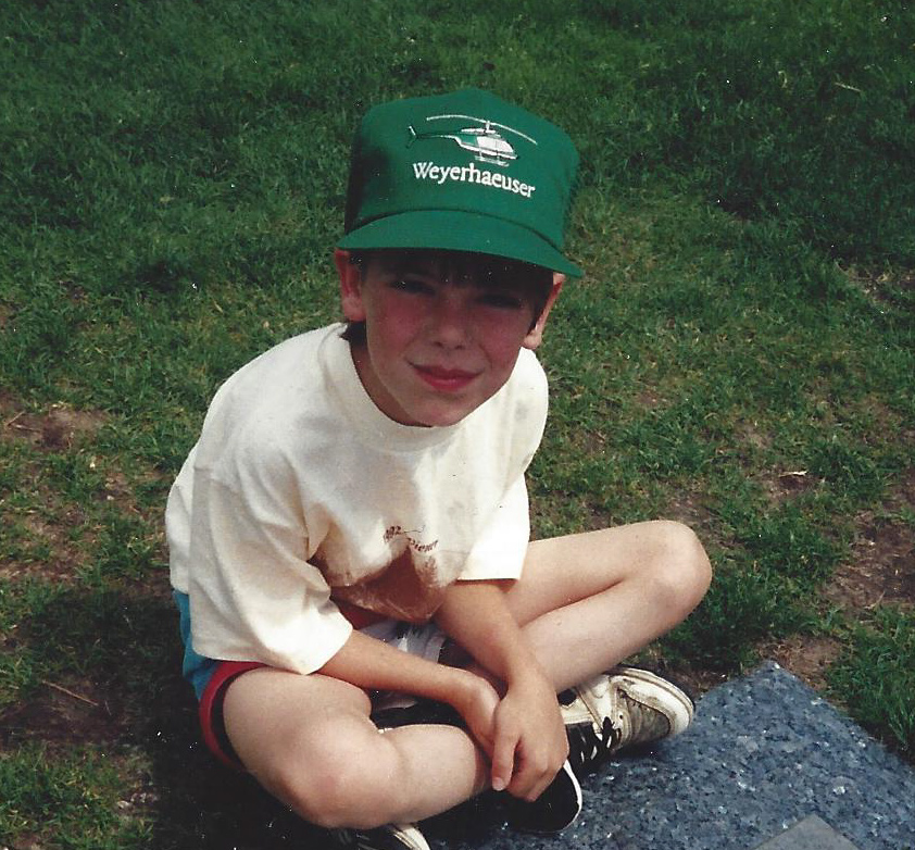 Image of Josh Dill at 9 years old, ready for a helicopter ride with his uncle.