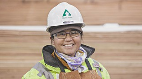 Woman in PPE smiling at the camera.