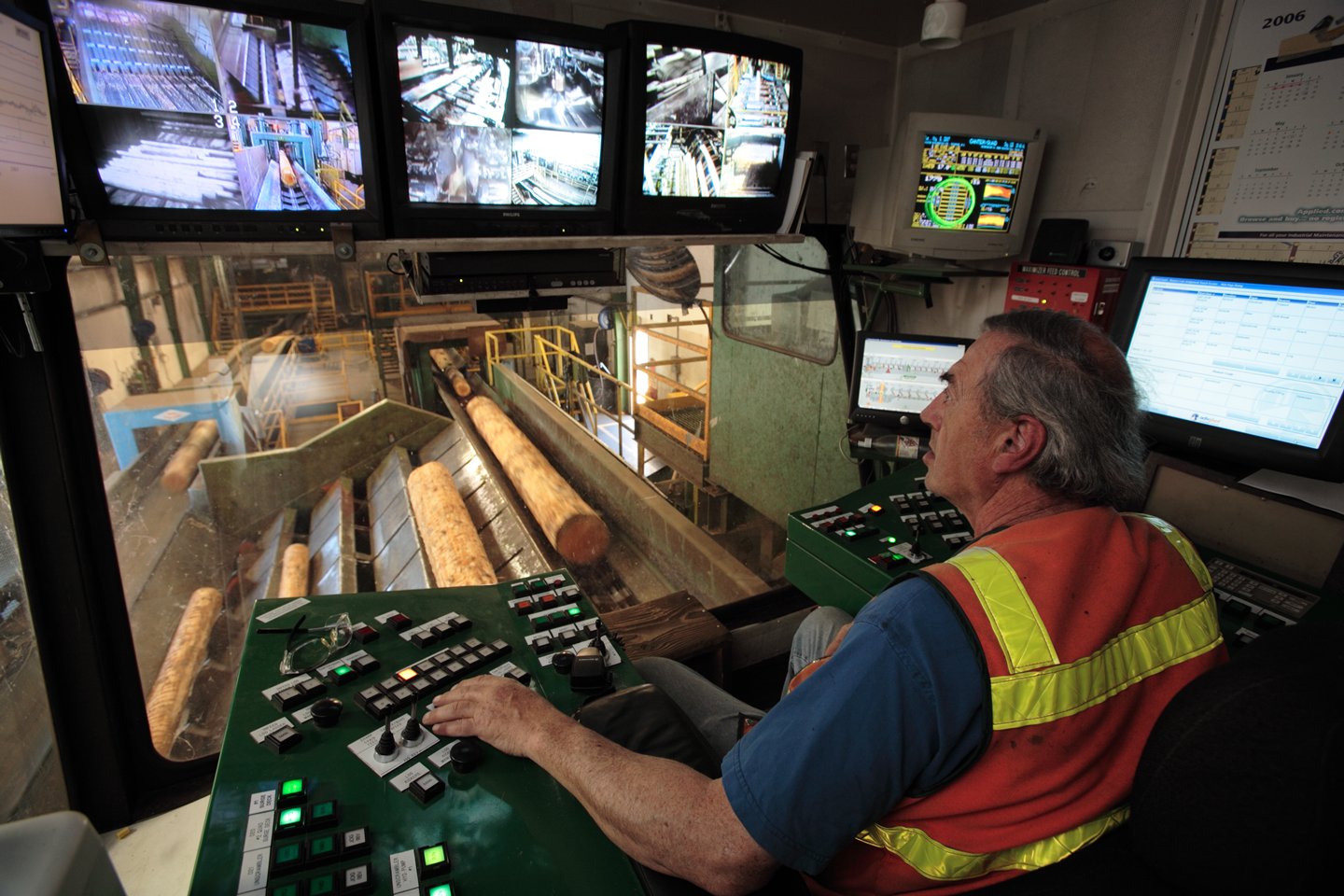 Image of a man sitting in a control room and viewing monitors.