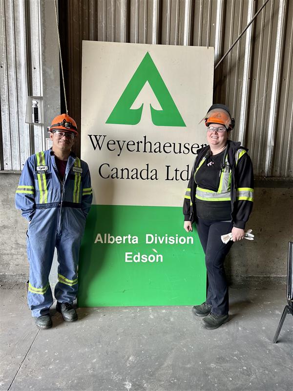 Image of employees standing in front of old Weyerhaeuser sign.