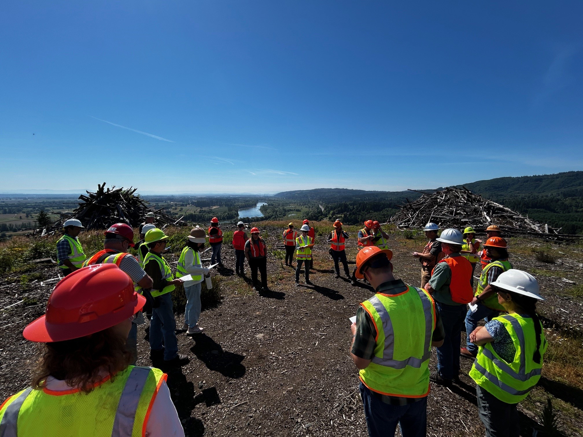 Groups of people standing around a clearning for the Tualatin Mountain Forest.