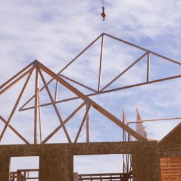 Image showing a frame of spruce pine fir MSR lumber being lowered onto a building.