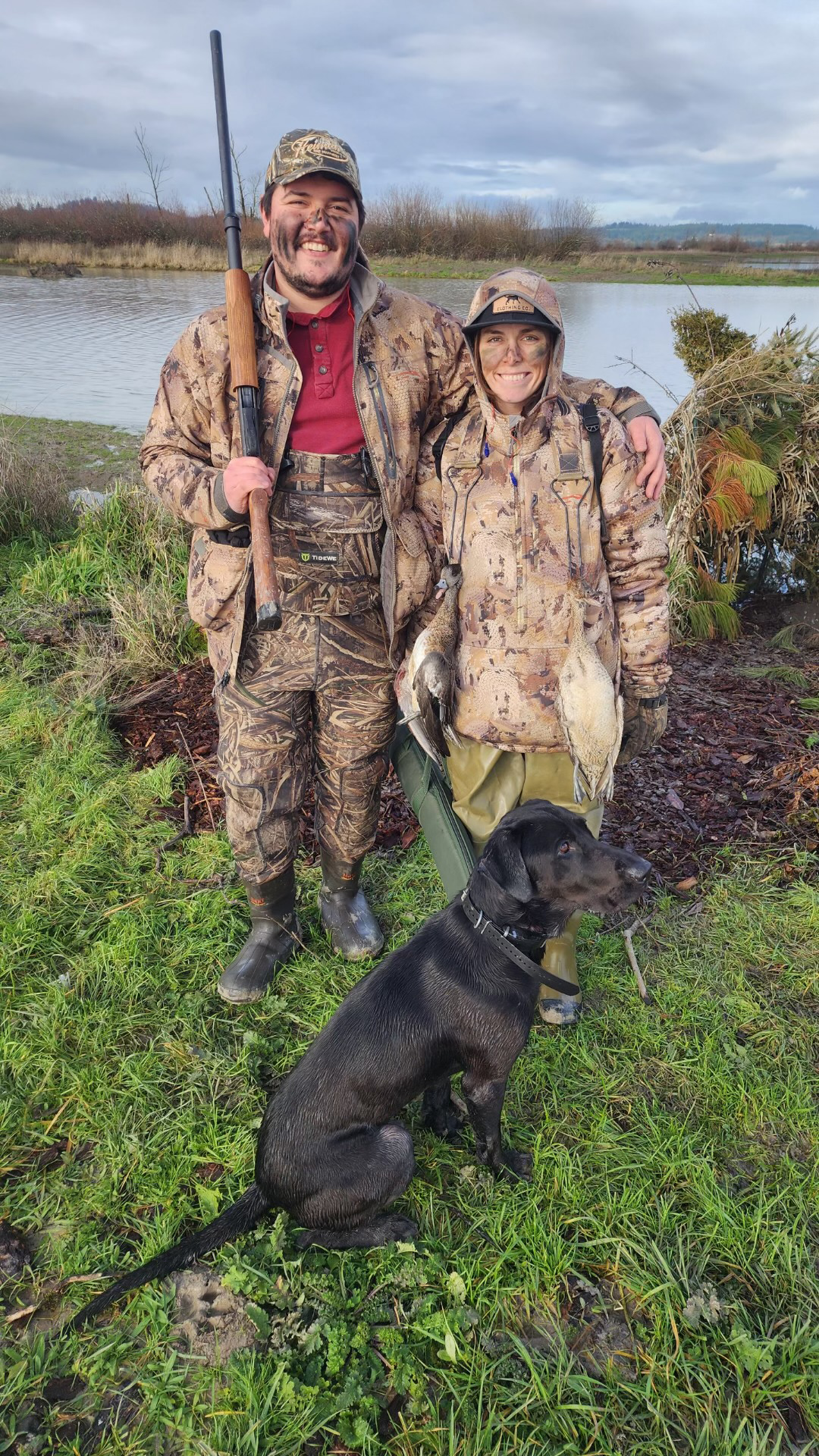 Image of Catherine and her fiance dressed for duck hunting. They are both wearing camouflage and have their faces painted.