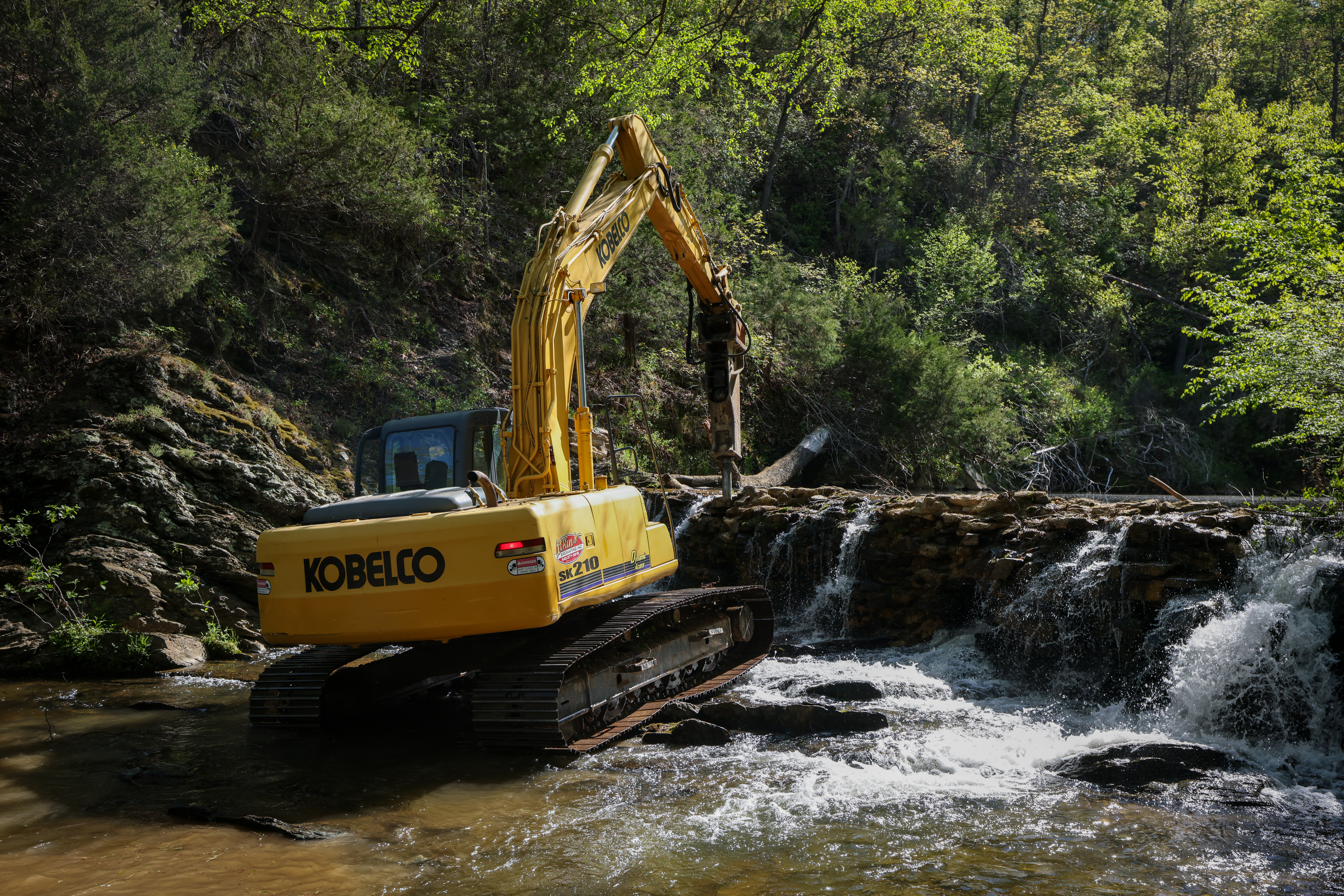 Image of the excavator removing the old dam.