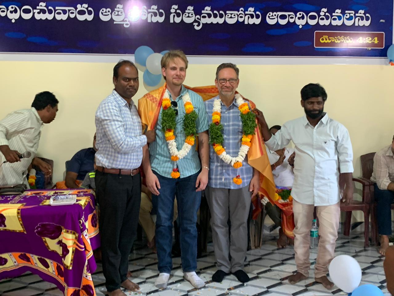 Image of Scott, right, with his son Brendan at a church dedication ceremony in Kattakur.