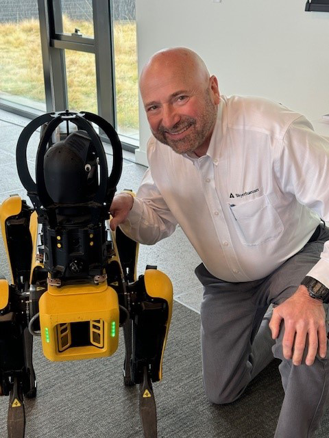 Image of Gary with robotic dog Spot at the Innovation Summit at our Seattle Headquarters earlier this year.