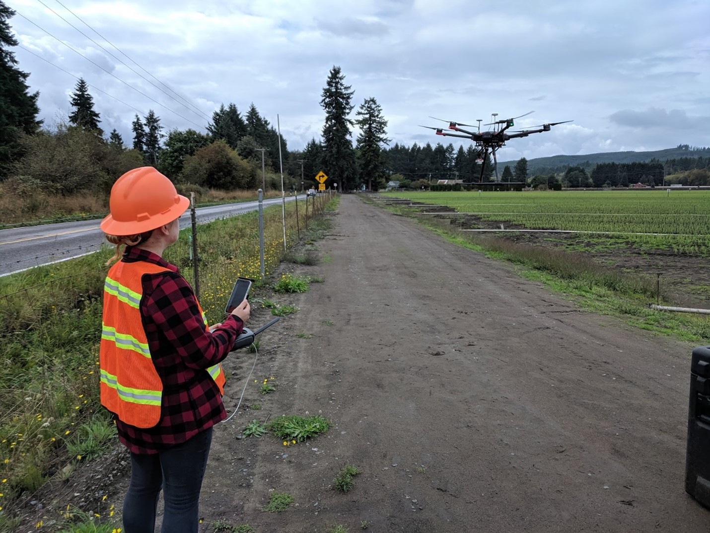 Image of Caleigh flying drones at the Mima Nursery.