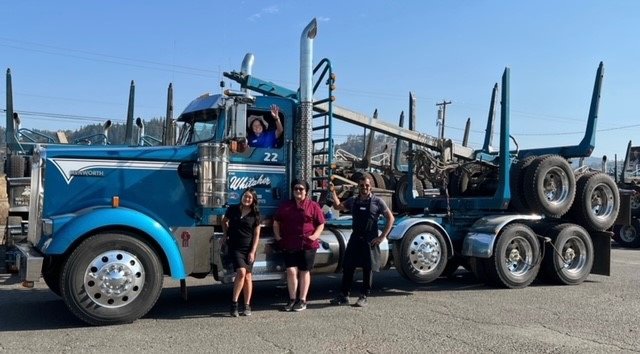 Image of catering staff checking out a Whitaker truck during the anniversary celebration.