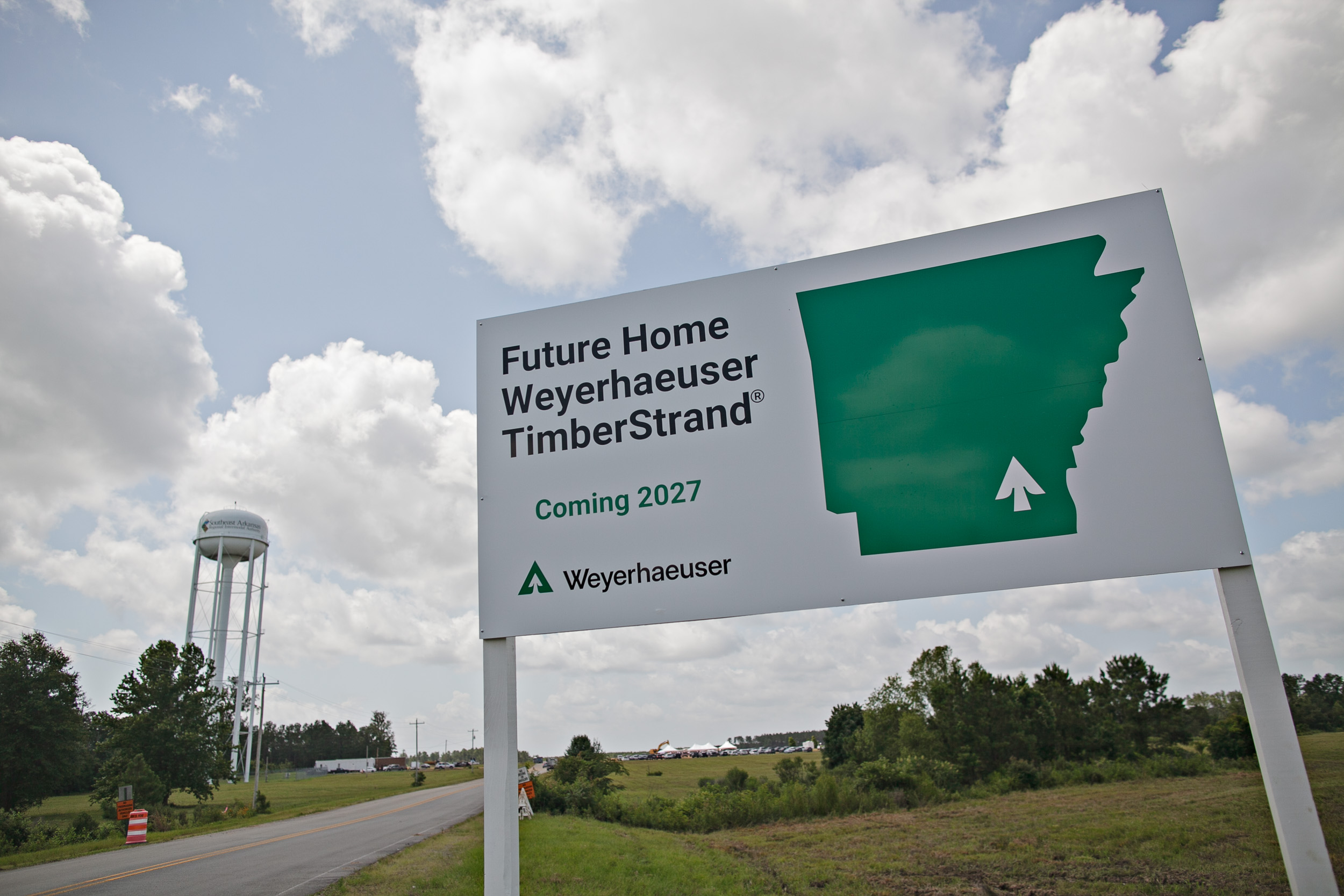 Image of a white sign that says "Future Home of Weyerhaeuser TimberStrand Coming 2027."