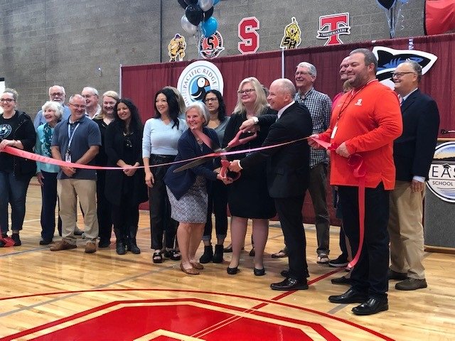 Doug, school board members past and present, former Seaside students, and community members cut the ribbon to officially open the new campus.