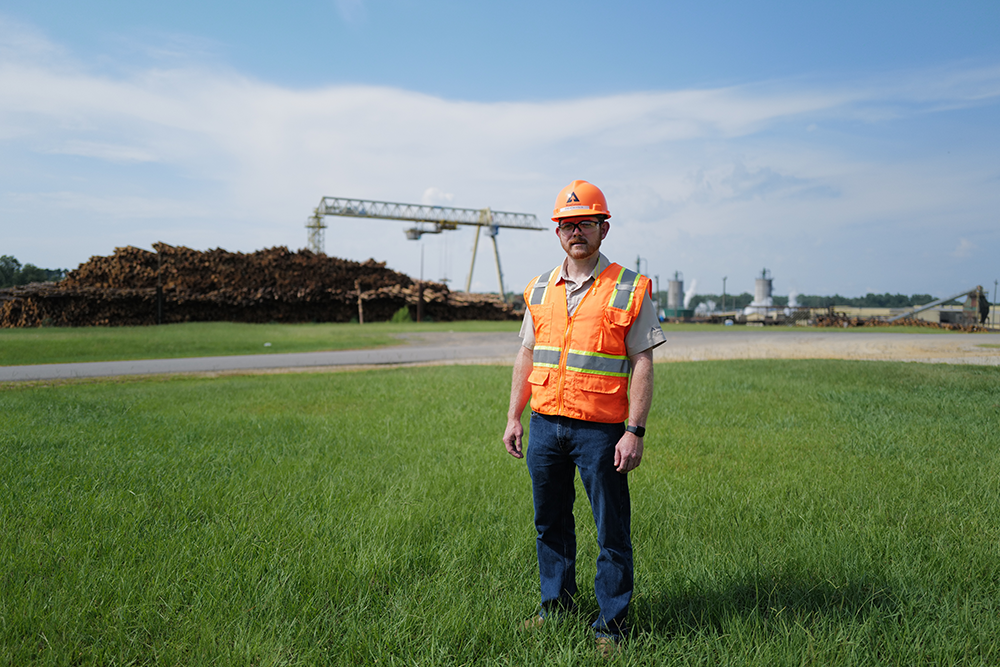 Image of a Weyerhaeuser employee standing in a field in Philadelphia, Miss.