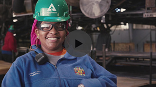 Image of a smiling employee in a warehouse.