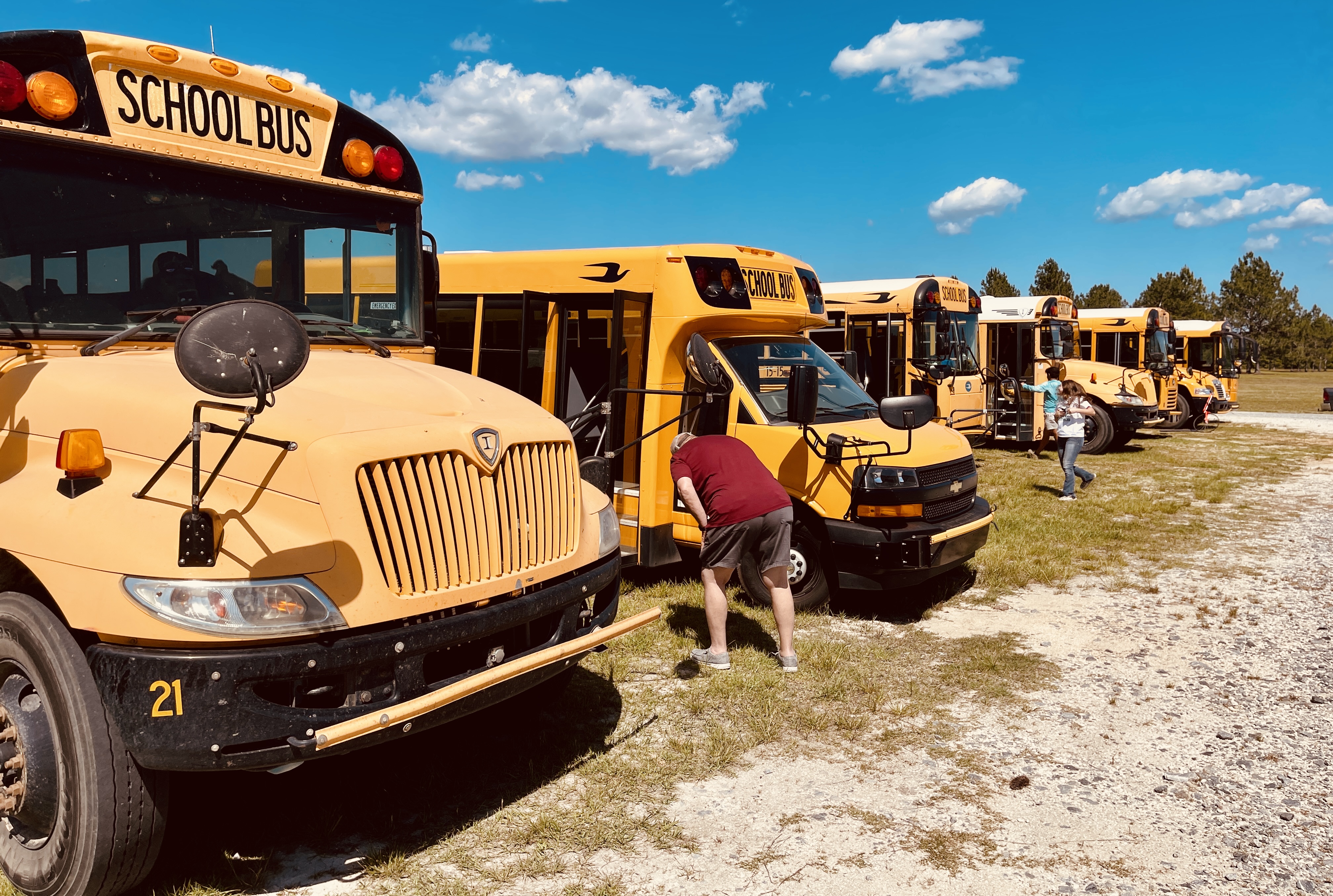 Image of buses that transported 26 teams of students in grades 6 through 12 to the Forestry Field Day at McKinnon.