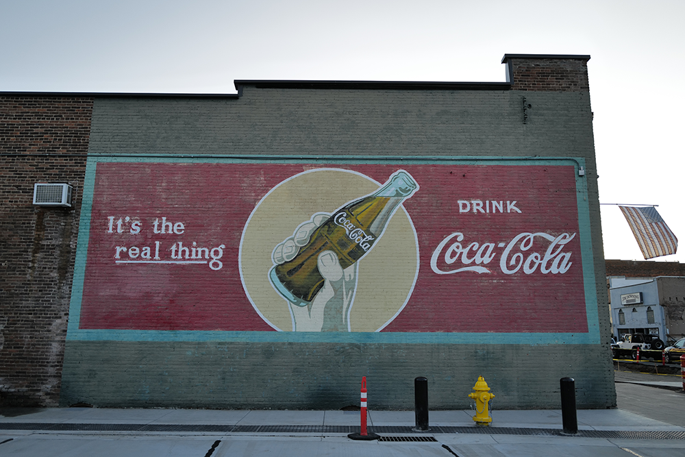 Image of a Coca-Cola mural on a business exterior wall in downtown Cottage Grove.