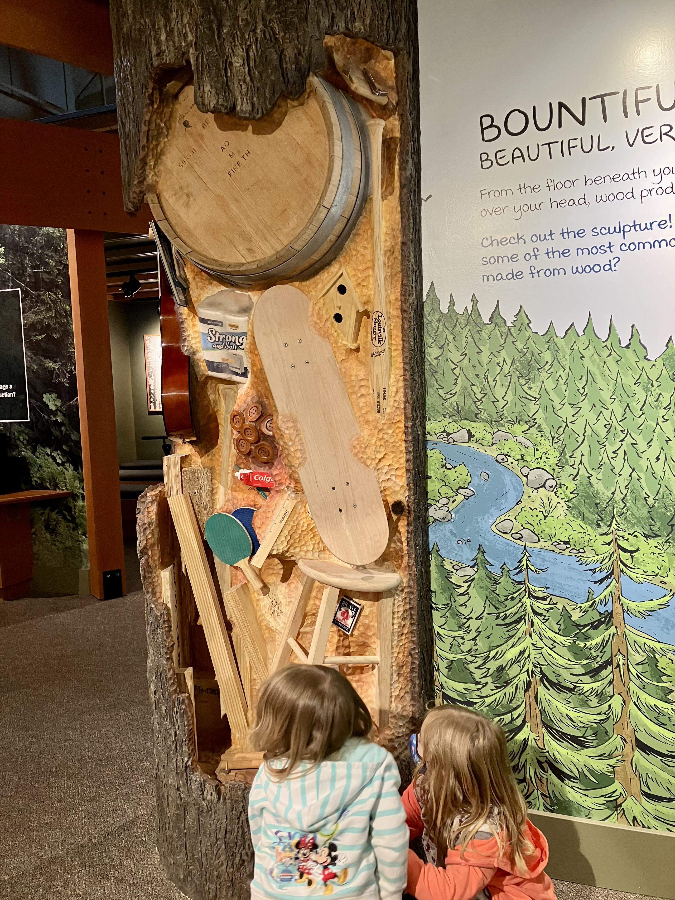 The new tree sculpture with products made from wood emerging out of the trunk.