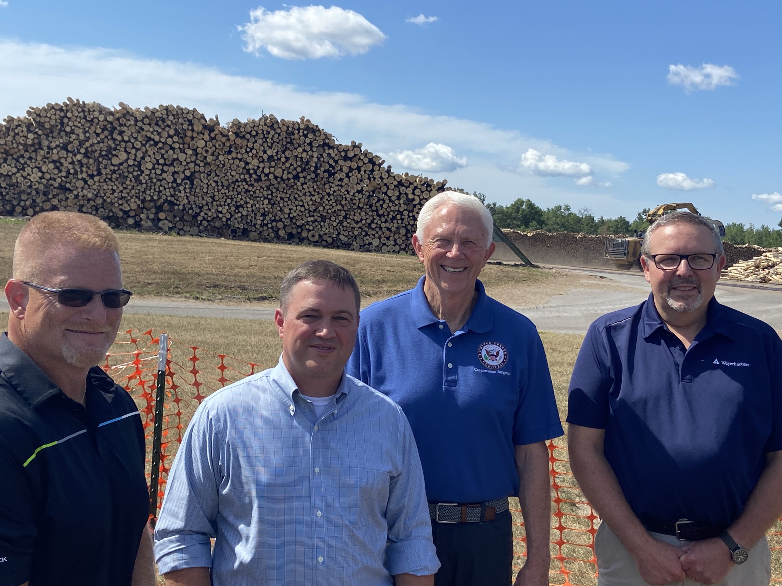 Steve Cutlip (panels manufacturing director), Ryan Beaver (vice president of Panels), Michigan Congressman Jack Bergman, Bruce Milligan (Grayling mill manager) in front of the Grayling woodyard during the 40th anniversary celebration.
