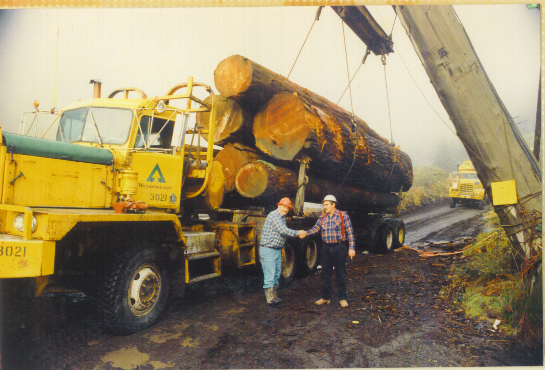 Ed Boren and Don Wickendoll load up the last load of logs rafted down the river from the Allegheny log camp in early 1989.