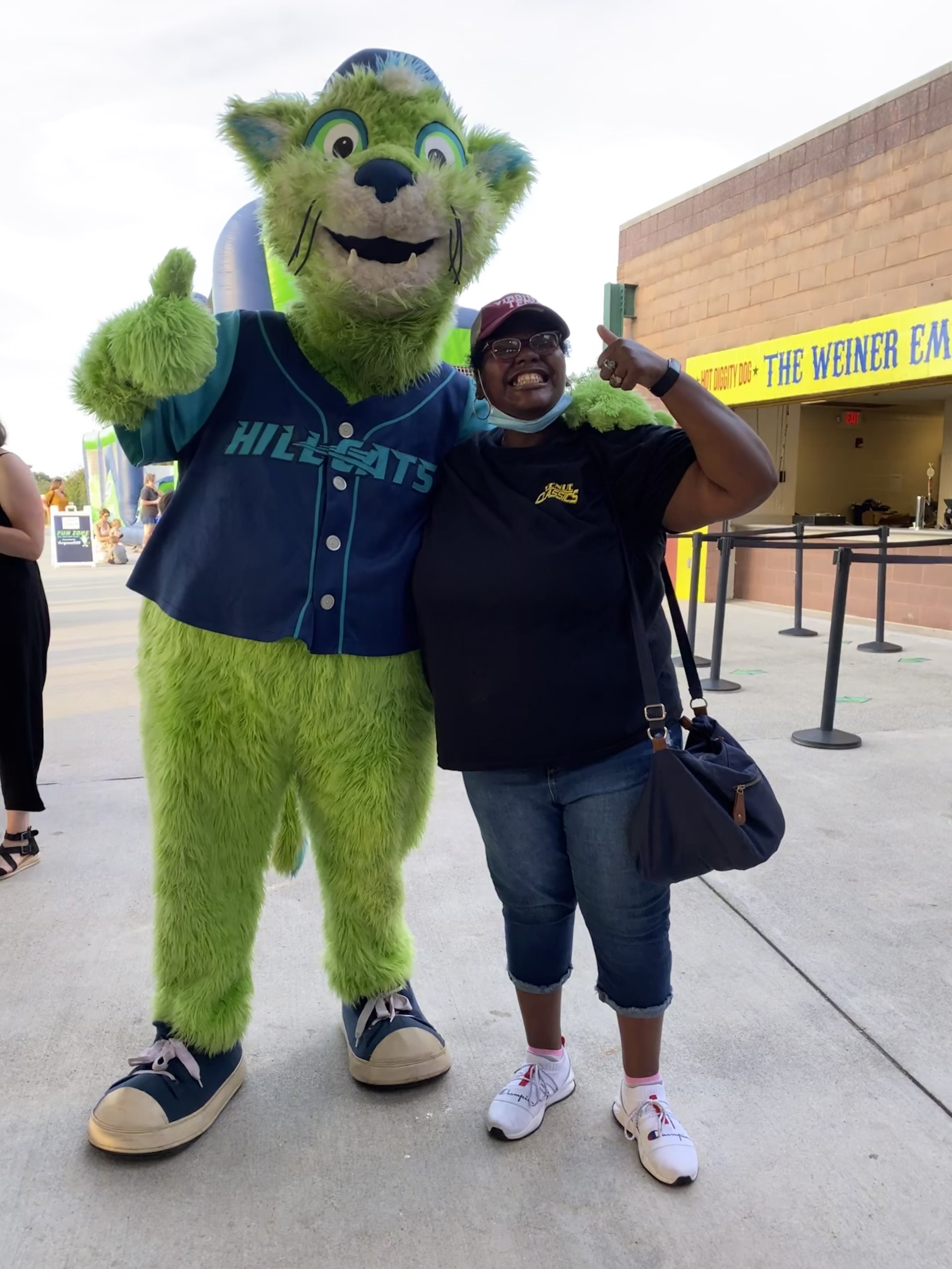 A Timberlands team member poses with the Hillcats mascot.