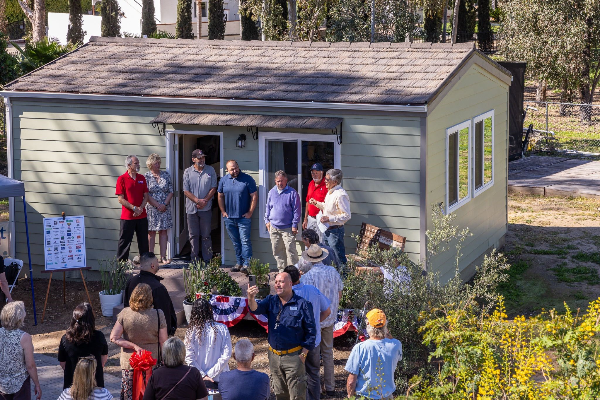Image of a ribbon-cutting ceremony for the first house built by San Marcus High School students and donated to the Wounded Warrior Homes.
