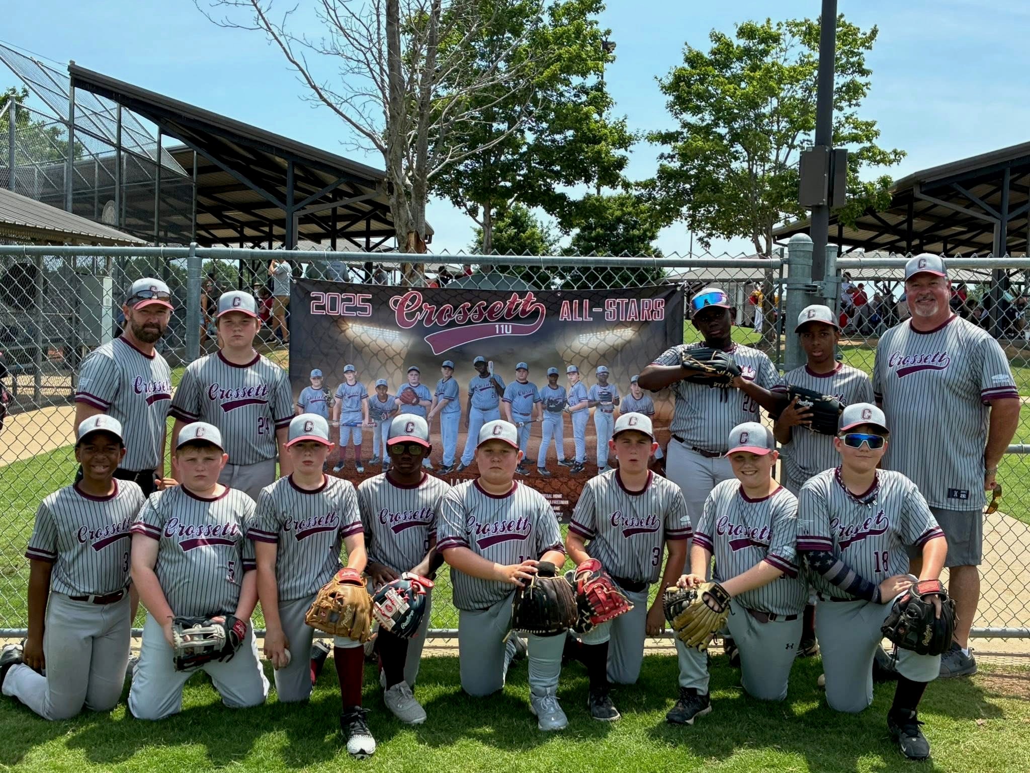 Image of Joe with an all-star baseball team he coaches. The plaeyrs are lined up in two rows with coaches on either side of the back row. Joe is on the right side of the image.