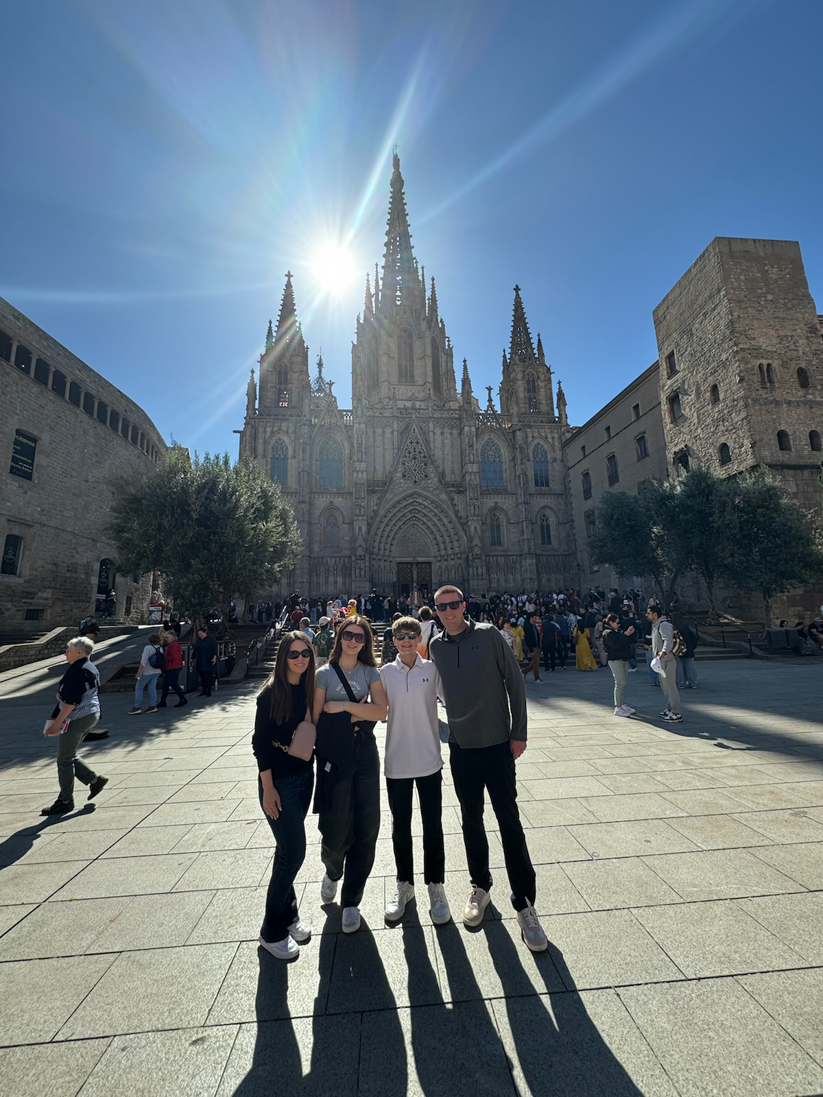 Image of Leta and her family standing in front of the Temple Expiatori del Sagrat Cor in Barcelona, Spain.