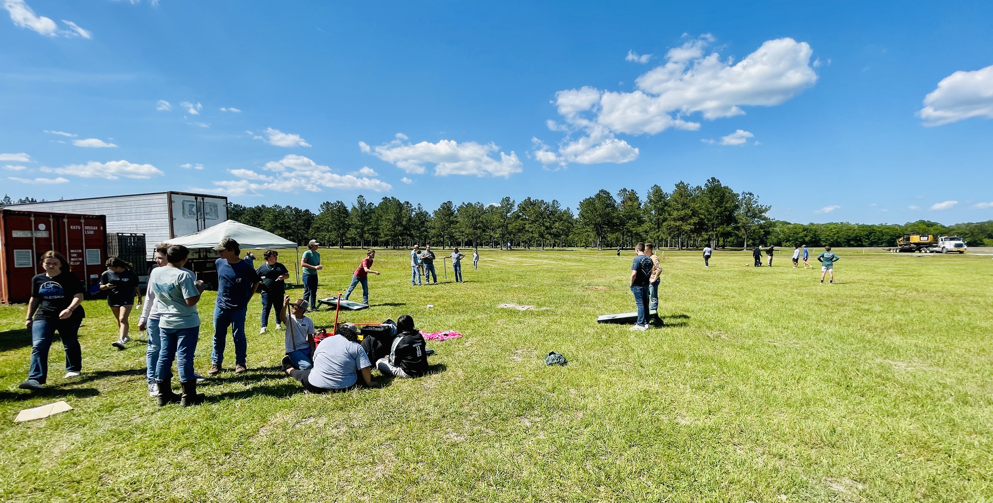 Image of students taking a break between events with lawn games and a sno-cone truck.
