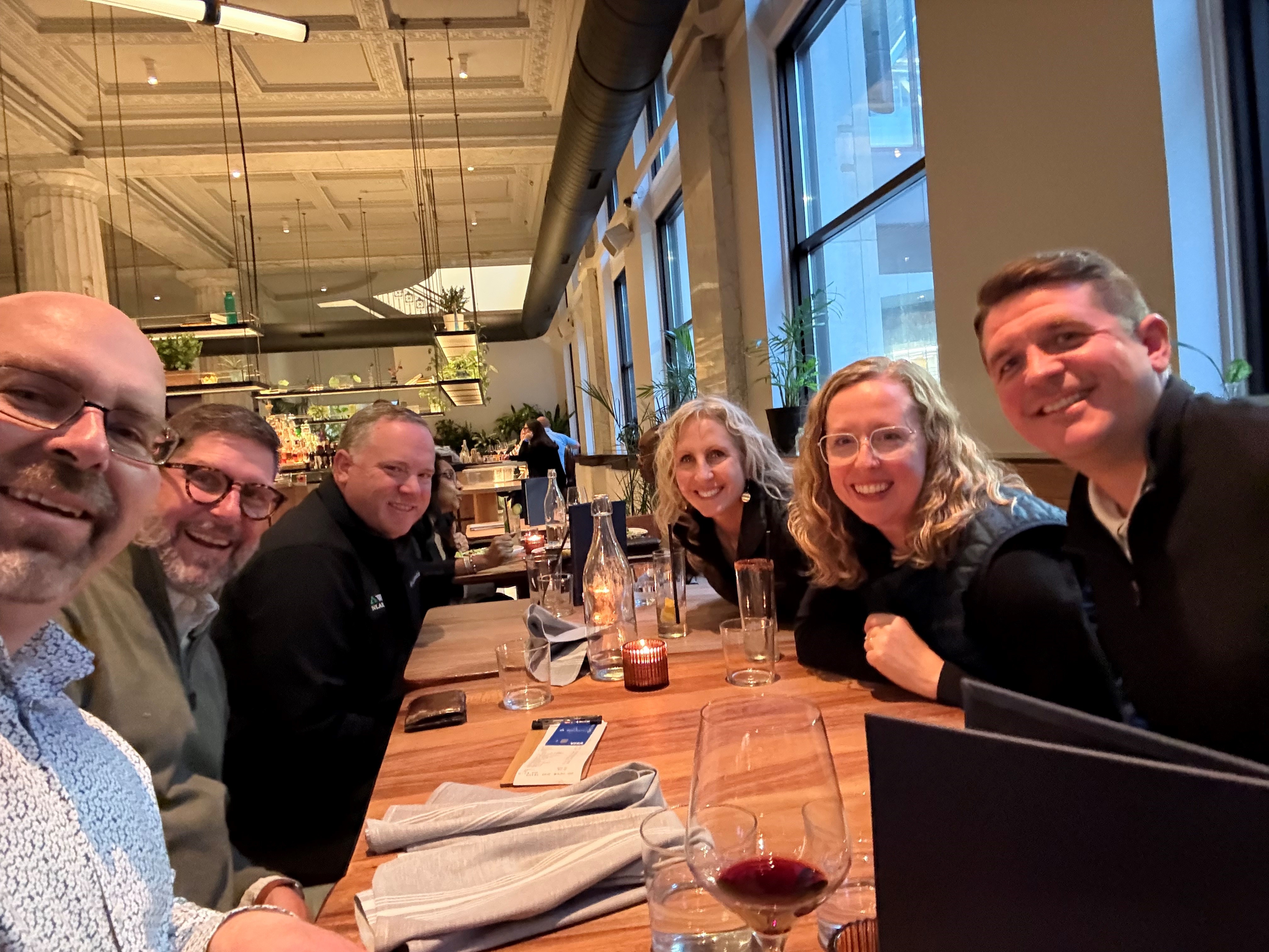 Image of several Weyerhaeuser employees taking a selfie while dining.