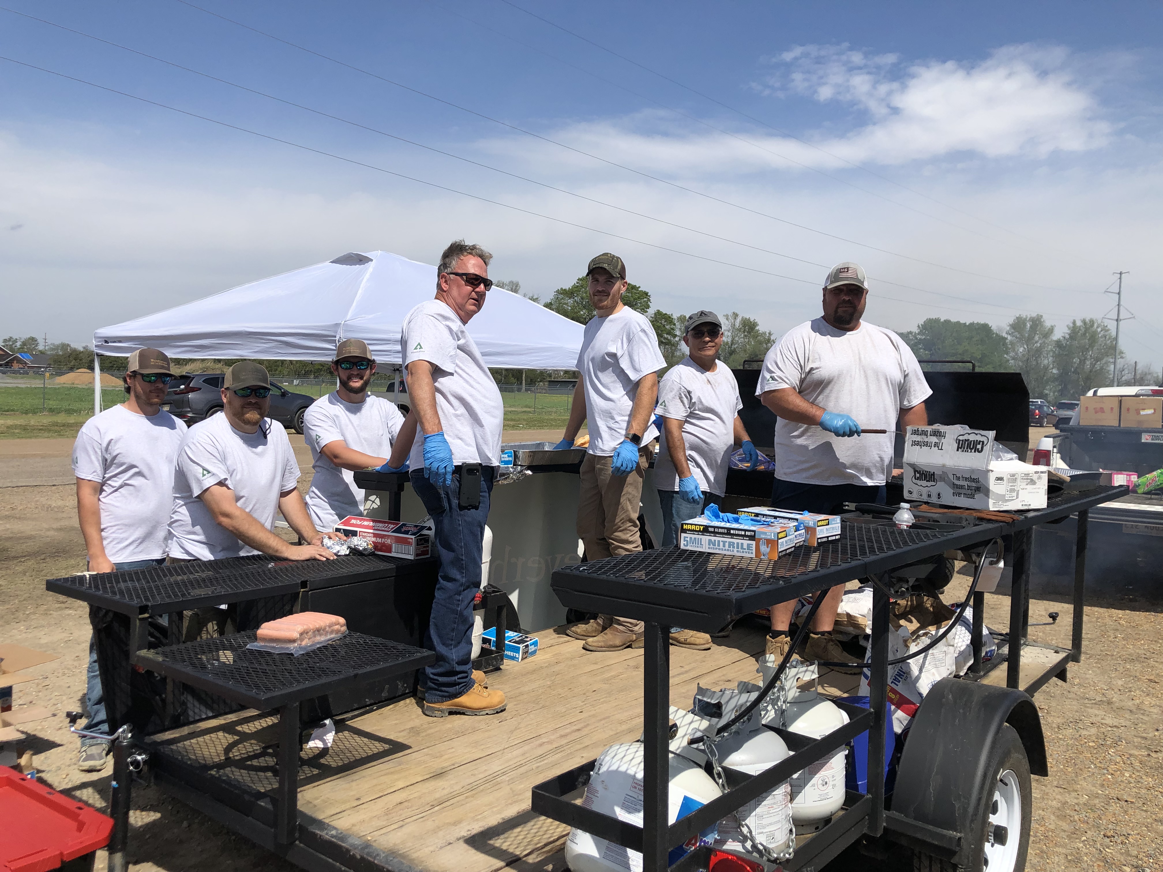 Image of volunteers getting the trailer ready for grilling and meal prep in Rolling Fork.