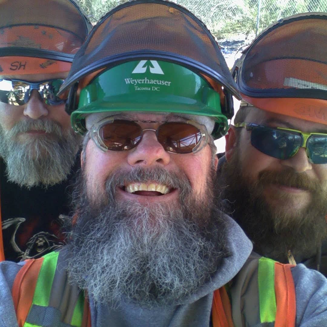 Image of three men with large beards who are also wearing hardhats, sunglasses and other personal protective equipment. Bob in on the right side of the picture.