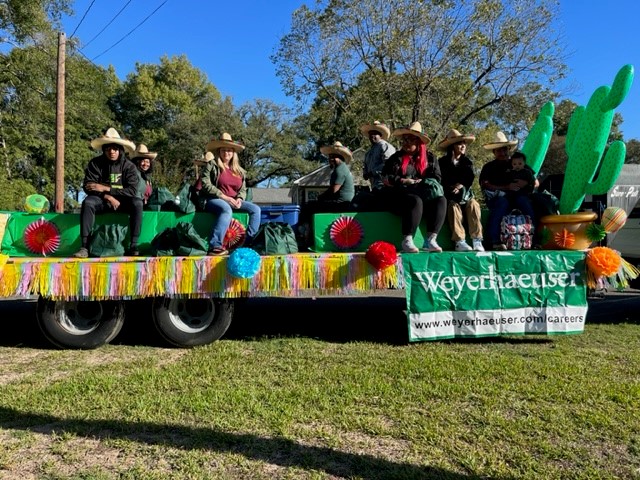 Image of employees representing Weyerhaeuser on the float as the community celebrates the Zwolle Tamale Fiesta.