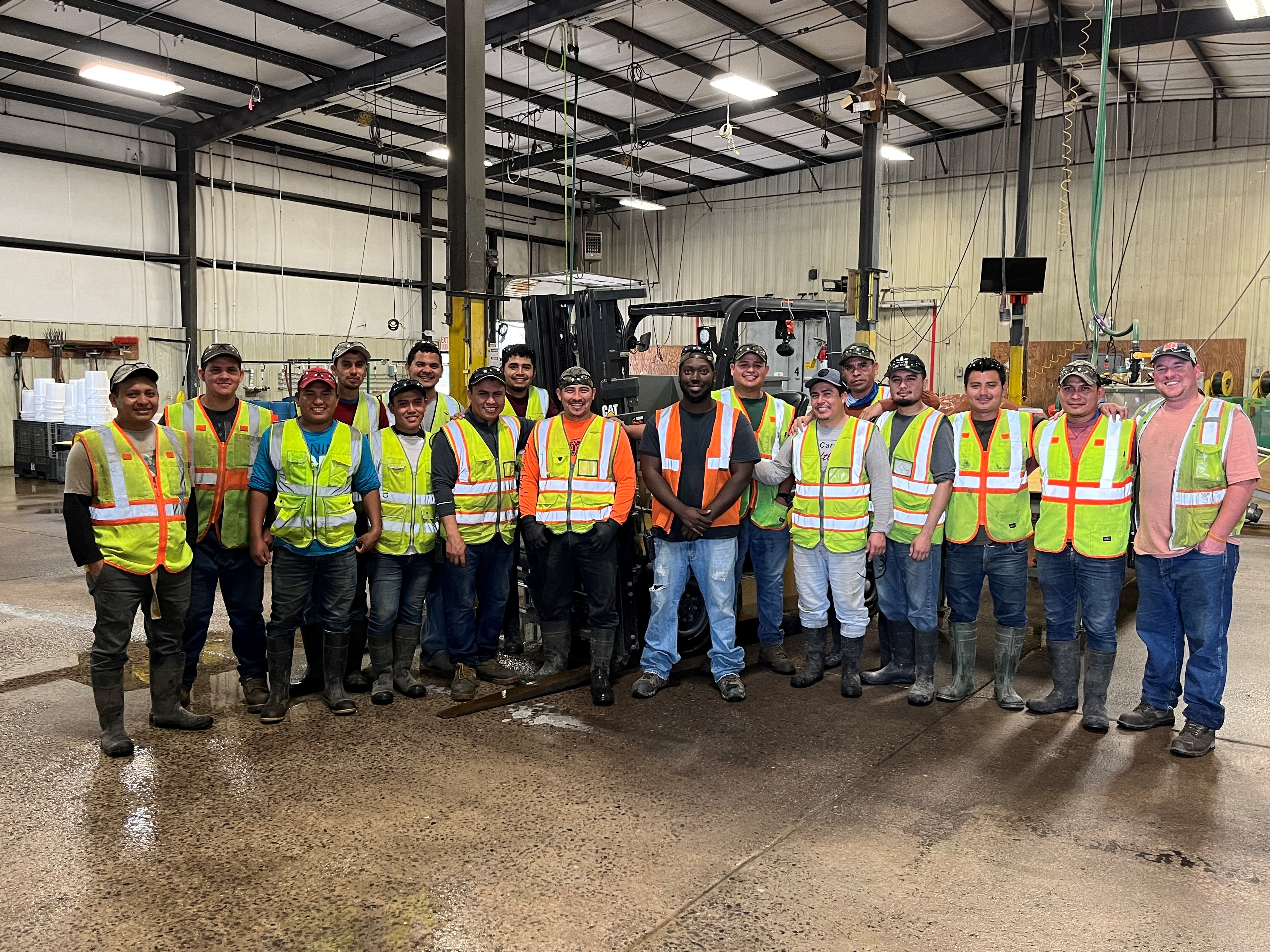 Image showing many people wearing PPE and safety vests with Marquess standing in the middle of the picture.