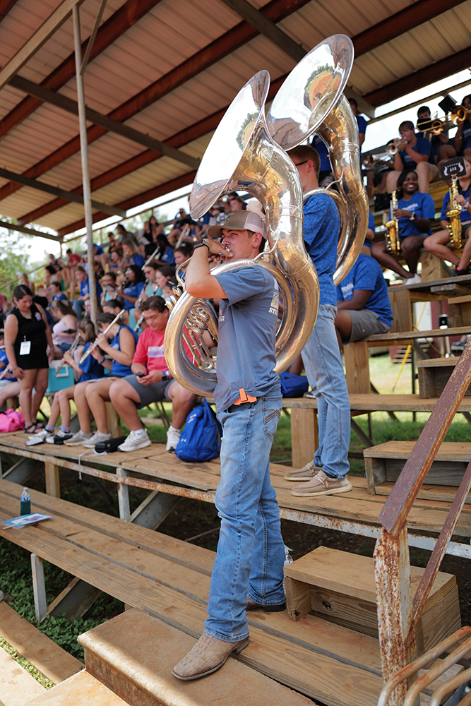Image of a tuba player in the stands at the harness races at the Neshoba County Fair.