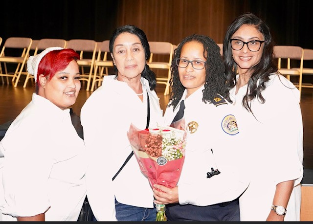 Image of Evelle, right, with her sister Monica, left, mother Deborah and sister Raven when Raven was promoted to captain in the New Orleans police department.