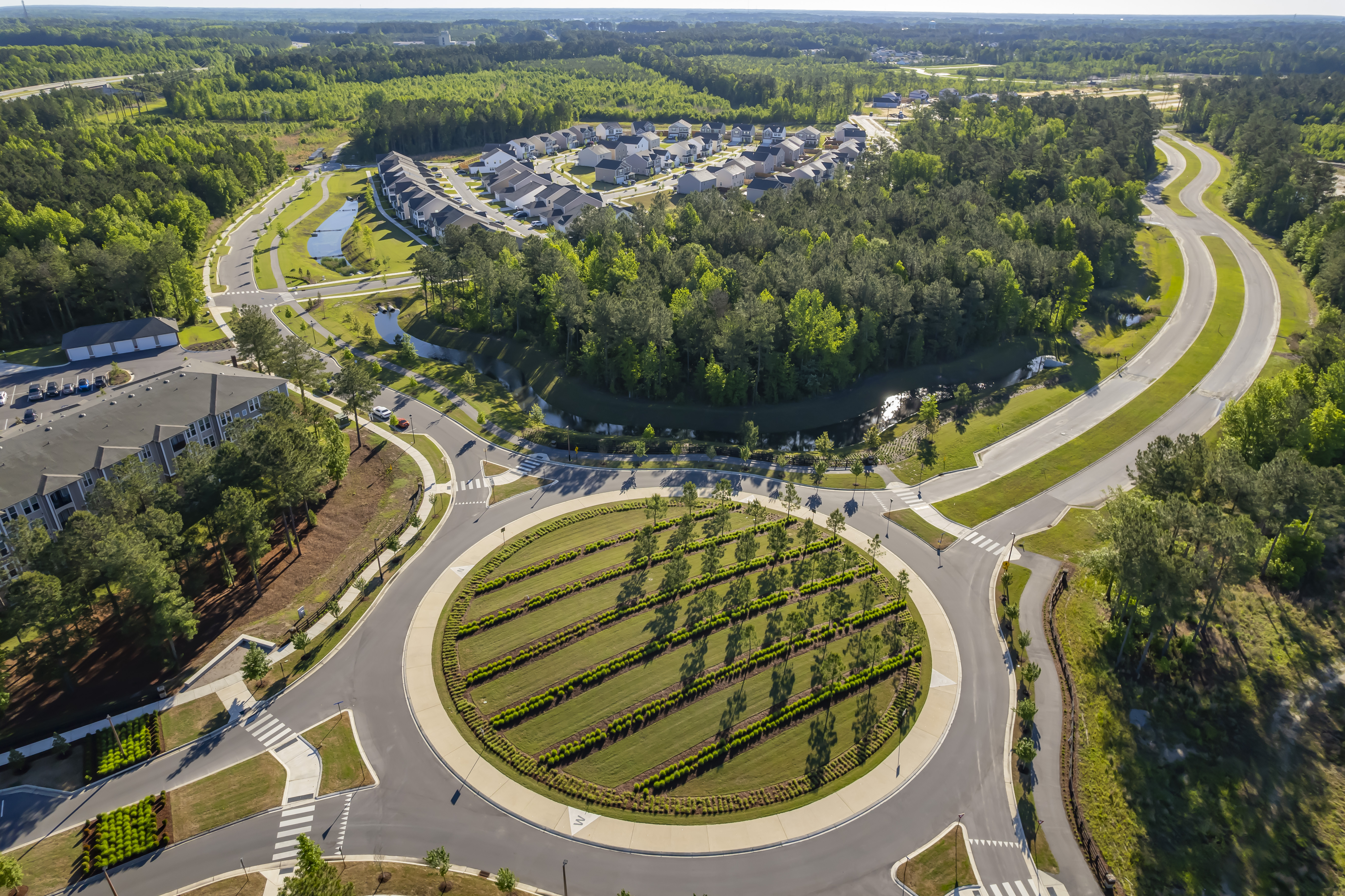 Image of the grand entrance to West New Bern preserves many of the pine trees planted years ago by our Timberlands team.