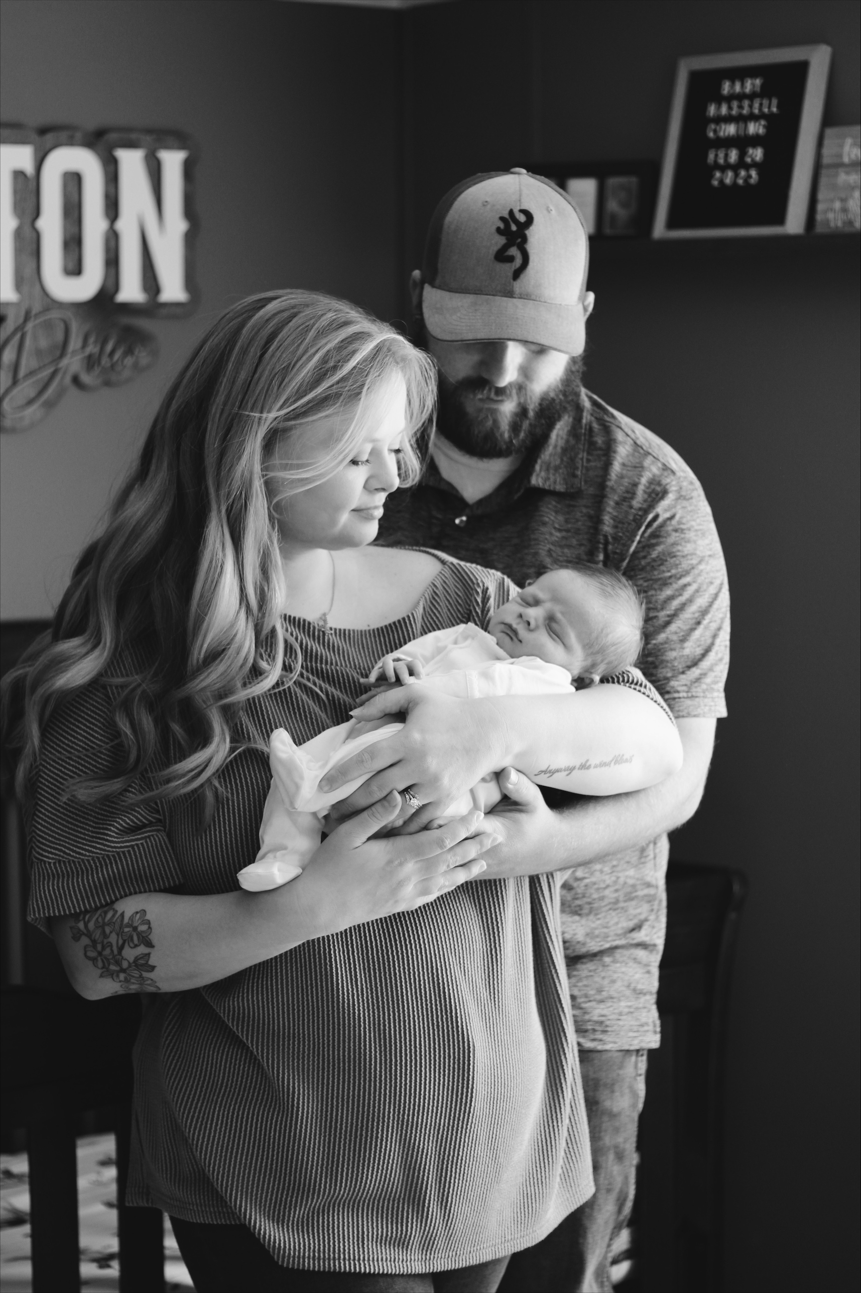 Black and white image of Carmen holding baby Houston as Gentry stands to the back.
