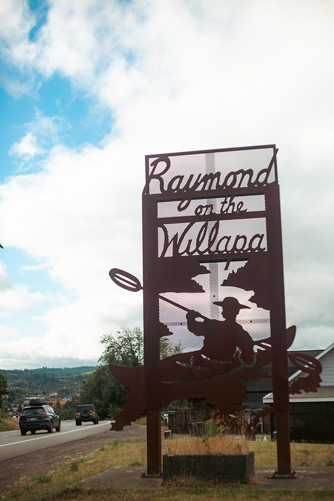 A sign welcomes visitors to Raymond, Washington.