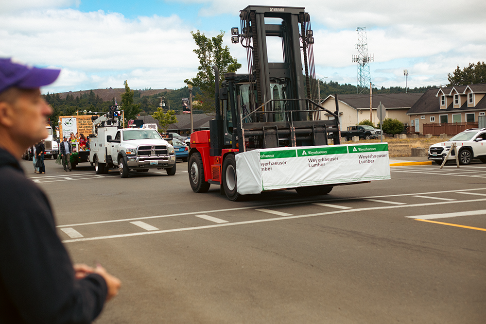 A forklift carries a pile of Weyerhaeuser OSB during the Willapa Harbor Festival.