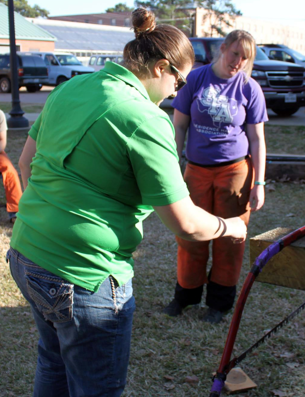 Image of Chelsea Lopez chatting with a member of the timbersports team she coaches.