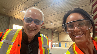 Image of Coutney McKee and a colleague who are both wearing protective goggles and safety vests.