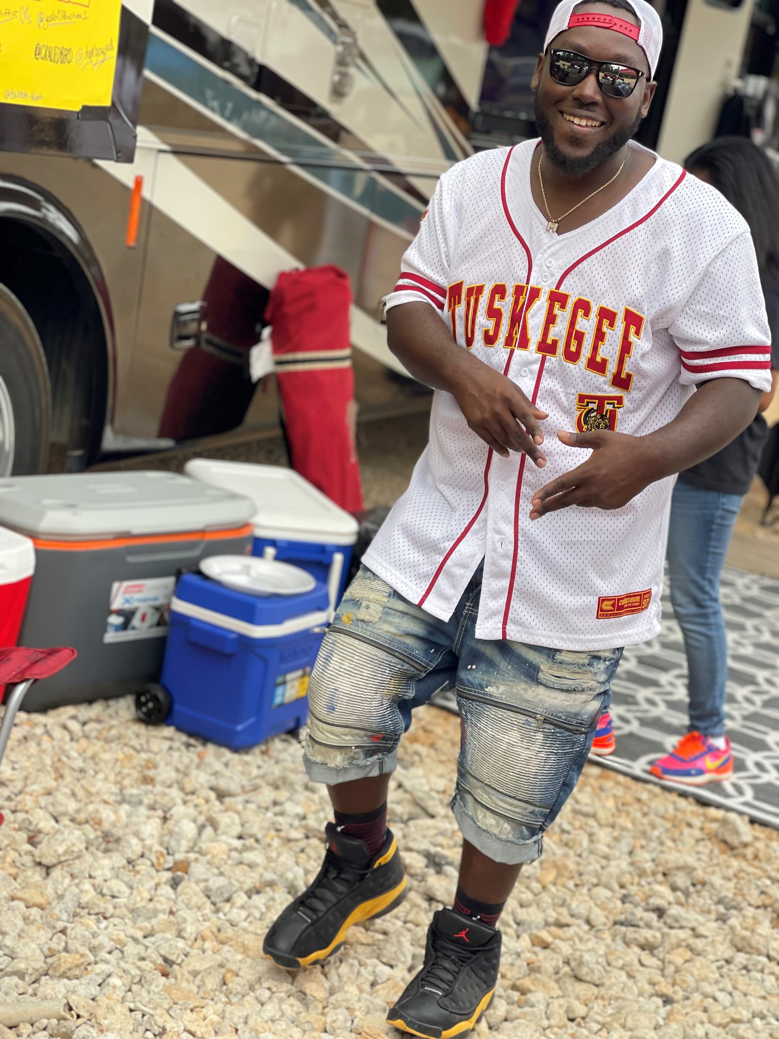 Image of Marquess wearing a Tuskeegee baseball shirt while attending homecoming weekend.