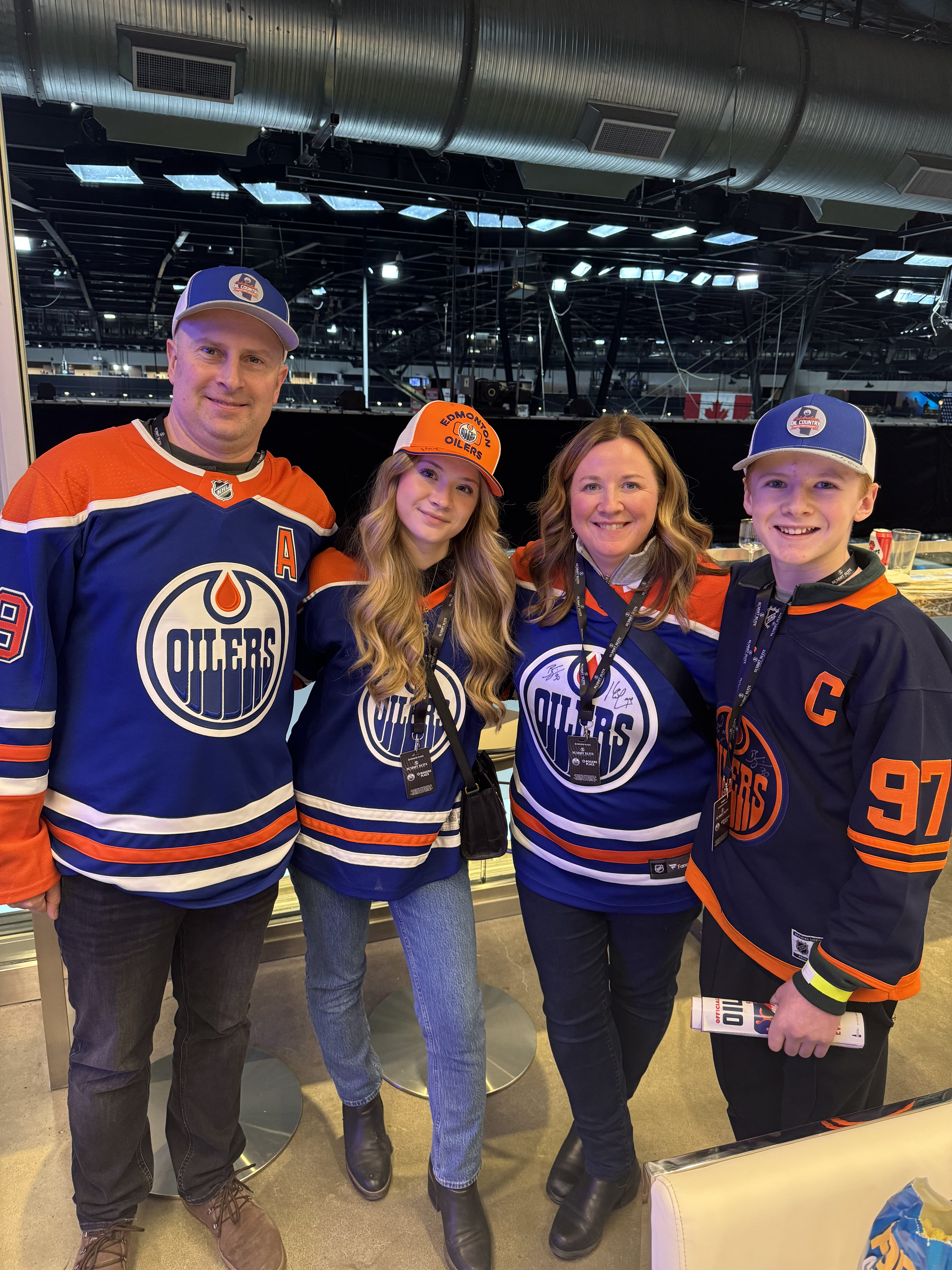 Image of Kerri with her husband and children all in Edmonton Oilers jerseys