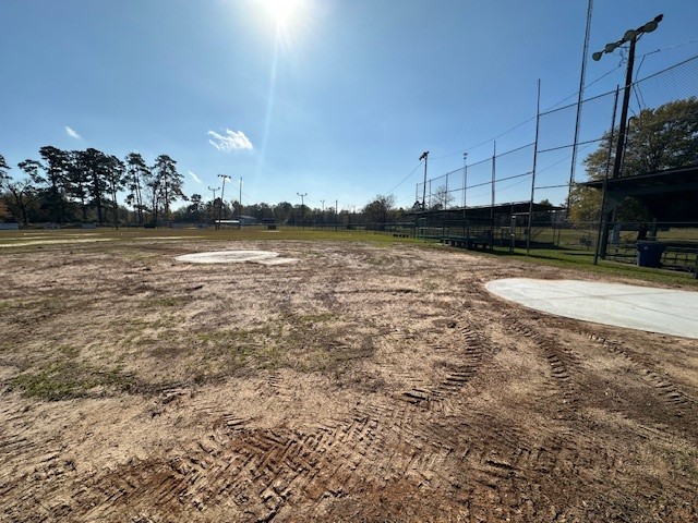 Image of the field during renovations. All that can be seen is dirt with fences on the right side of the image.