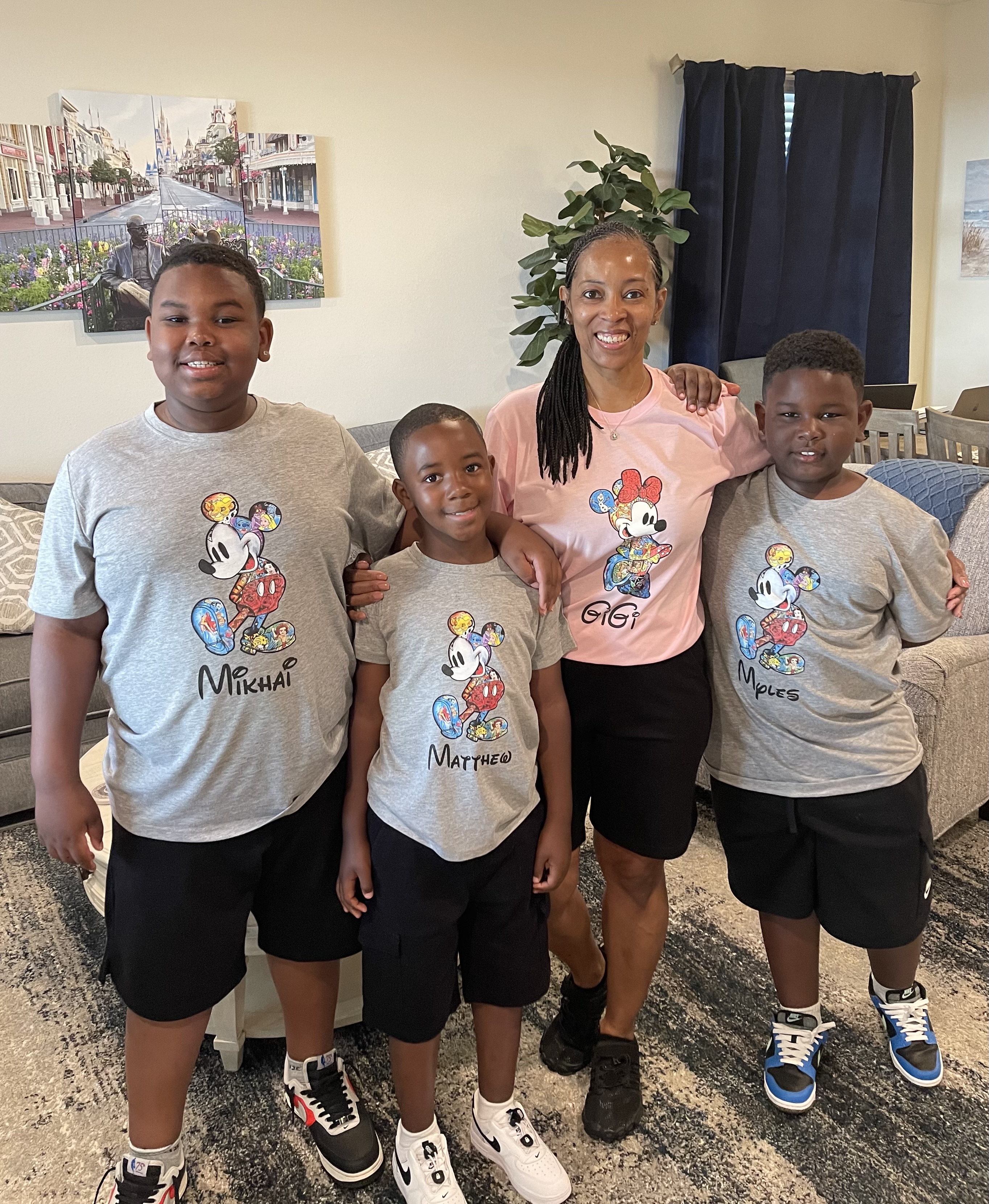 Image of Suzy with three of her grandsons: Mikhai, Matthew and Myles.