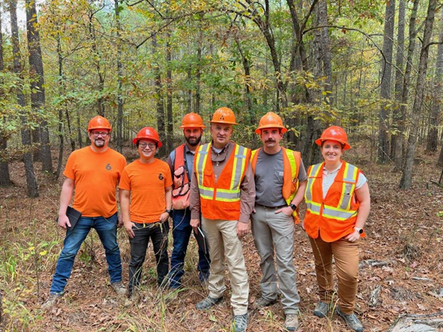 Image of Caleigh in the field with the Forest Carbon team and biometricians on the Advanced Forestry Systems team.