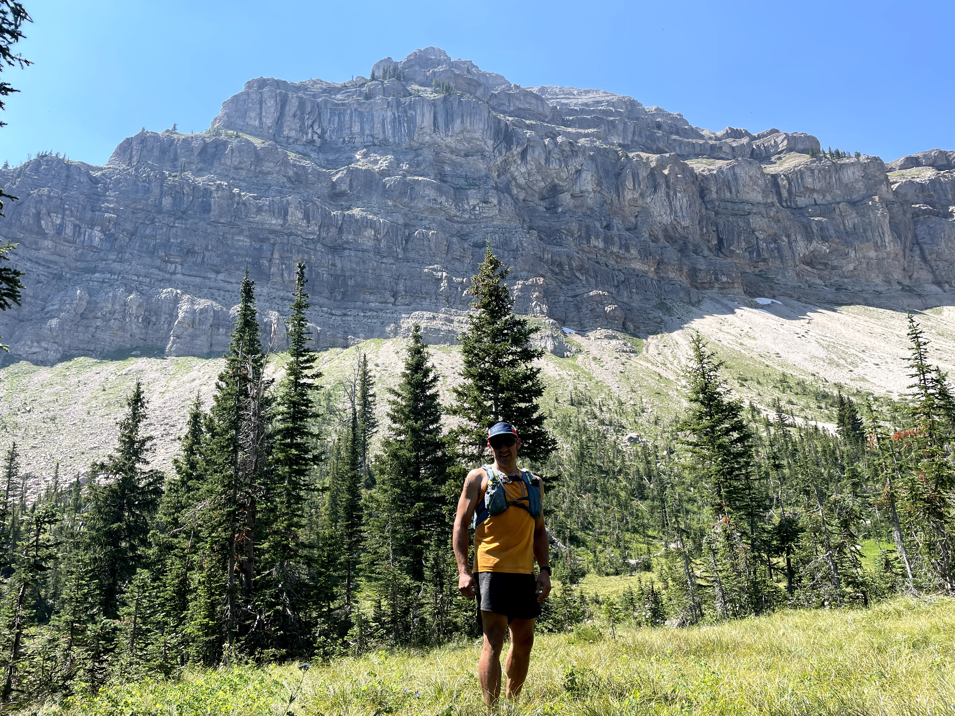 Image of Jared Richardson pausing below the Trilobite Peak during a 50-plus mile run in Montana.