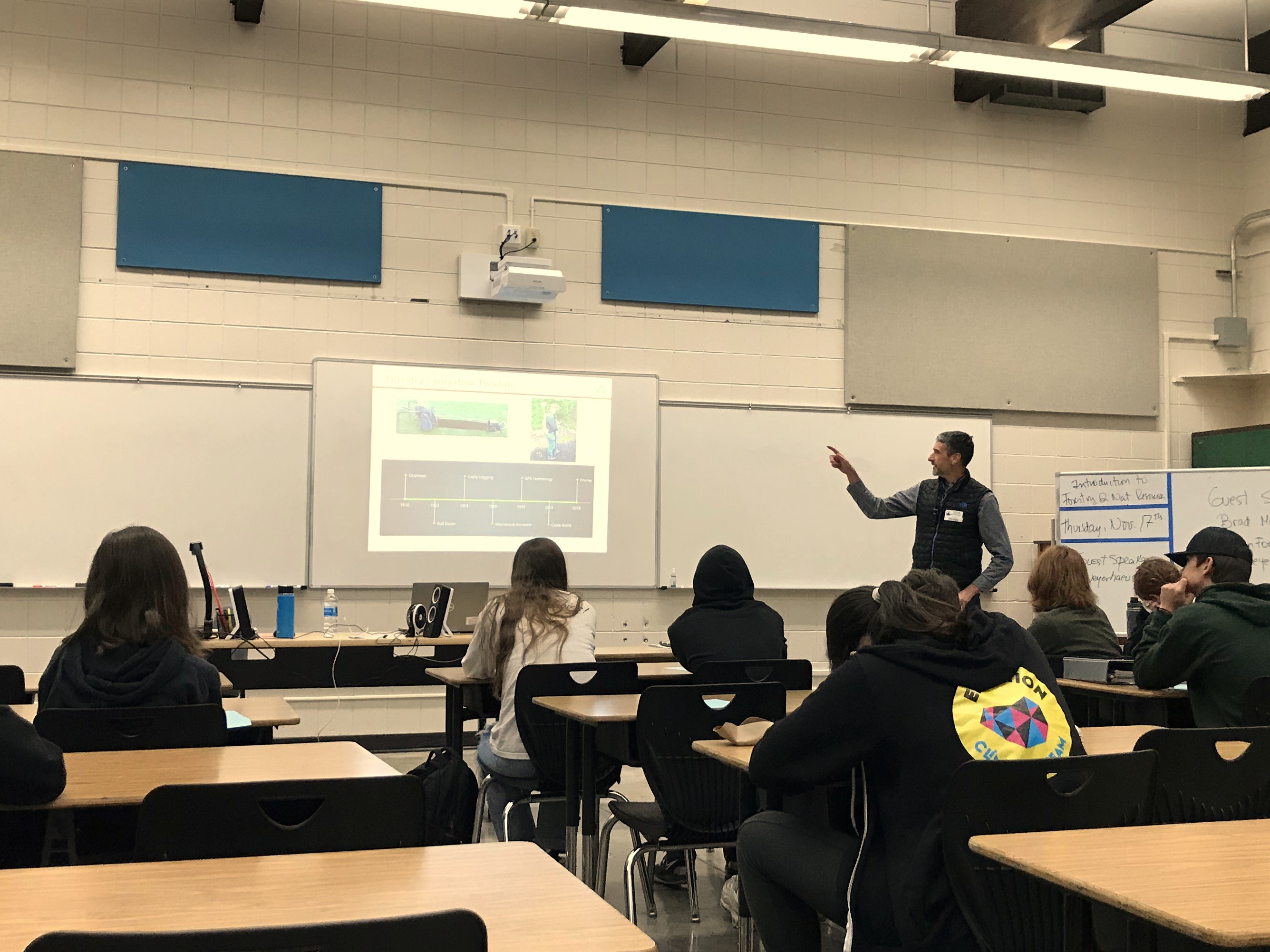 Image of Brad giving a presentation to a high school forestry class.